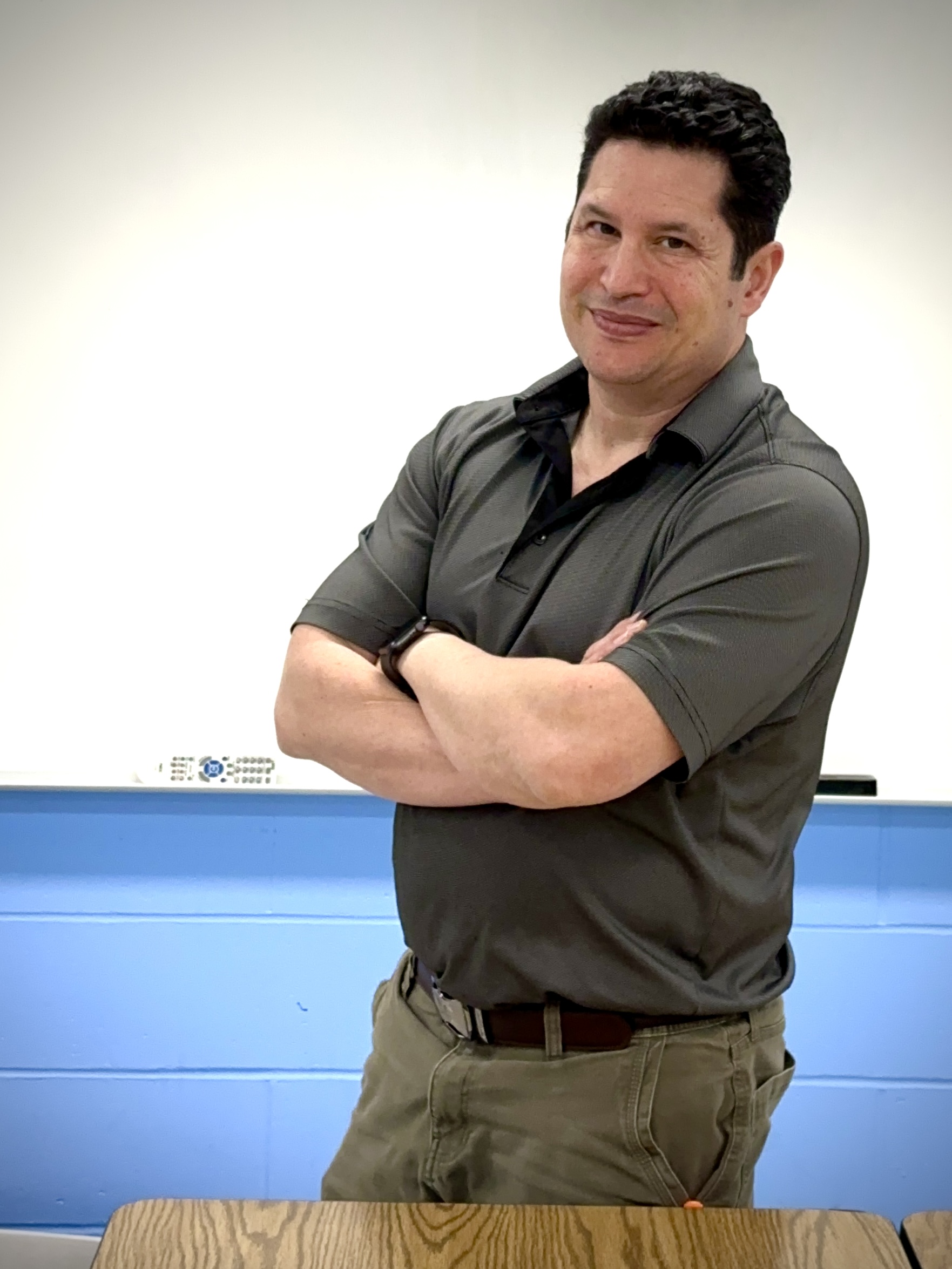 Marty, a 7th grade STEM teacher, standing in his classroom.